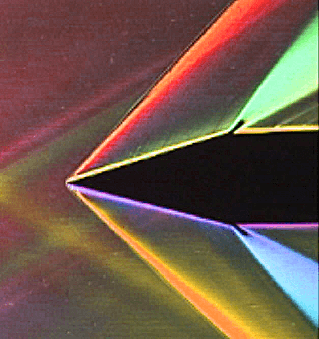 Two-dimensional Schlieren image of supersonic air flowing at Mach 2 over a wedge, with oblique shock waves followed by Prandtl-Meyer expansion fans; source: Penn State University Gas Dynamics Laboratory